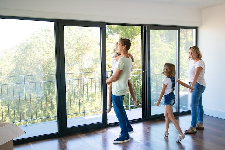happy-father-with-daughter-standing-near-open-balcony-smiling_74855-9994