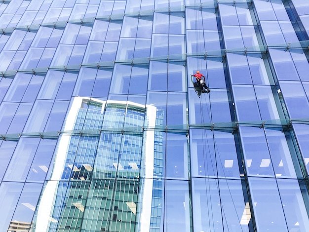 low-angle-view-man-cleaning-modern-building_1048944-10909880