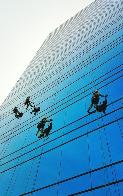 washers-cleaning-windows-skyscraper_1048944-6765995